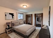 Thumbnail 4 of 19 - a bedroom with a bed and a dresser and a closet. Fargo, ND Patricia Ann Apartments