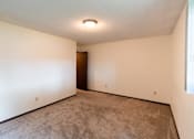 Thumbnail 9 of 19 - Fargo, ND Patricia Ann Apartments. A bedroom with a carpeted floor and white walls