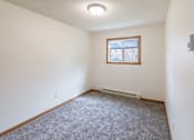 Thumbnail 15 of 19 - Fargo, ND Patricia Ann Apartments. A bedroom with white walls and carpet