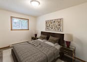 Thumbnail 7 of 19 - a bedroom with a bed and a window. Fargo, ND Patricia Ann Apartments