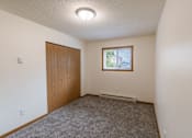 Thumbnail 14 of 19 - Fargo, ND Patricia Ann Apartments. A bedroom with a door and a window
