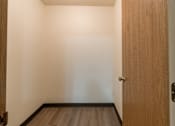 Thumbnail 18 of 19 - Fargo, ND Patricia Ann Apartments. A small room with a wooden door and hardwood floors