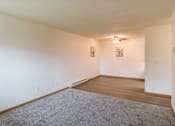 Thumbnail 11 of 19 - Fargo, ND Patricia Ann Apartments. A living room and dining room with a ceiling fan in the dining room.
