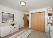 Thumbnail 3 of 15 - A bedroom with a bed and a dresser and a closet. Fargo, ND Pinehurst Apartments