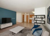 Thumbnail 1 of 15 - A living room with a couch and a coffee table and a televisio. Fargo, ND Pinehurst Apartments.