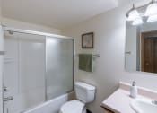 Thumbnail 28 of 36 - a bathroom with a shower and a sink and a toilet. Fargo, ND Place One Apartments