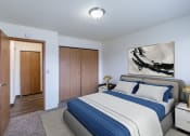 Thumbnail 3 of 36 - a bedroom with a bed and a closet. Fargo, ND Place One Apartments