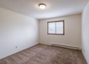 Thumbnail 23 of 36 - a bedroom with carpet and a window. Fargo, ND Place One Apartments