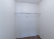 Thumbnail 27 of 36 - an empty room with a white wall and a white closet. Fargo, ND Place One Apartments