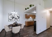 Thumbnail 2 of 36 - an open kitchen and dining room with a table and chairs. Fargo, ND Place One Apartments