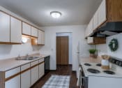 Thumbnail 21 of 36 - a kitchen with stove and sink. Fargo, ND Place One Apartments