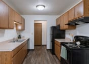 Thumbnail 32 of 36 - a kitchen with stove refrigerator and sink. Fargo, ND Place One Apartments