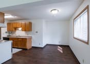 Thumbnail 30 of 36 - the view of a kitchen and living room with a large window. Fargo, ND Place One Apartments