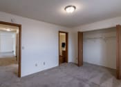 Thumbnail 14 of 36 - a bedroom of an empty apartment with a closet. Fargo, ND Place One Apartments
