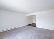 Thumbnail 8 of 36 - an empty living room with white walls and carpet. Fargo, ND Place One Apartments