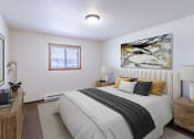 Thumbnail 3 of 14 - a bedroom with a bed and a window. Fargo, ND Plumtree Apartments