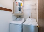 Thumbnail 11 of 14 - two washers and a dryer in a laundry room. Fargo, ND Plumtree Apartments