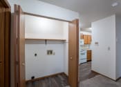 Thumbnail 20 of 32 - the view of a kitchen from a living room with wood floors and white walls. Fargo, ND  Prairie Park Apartments