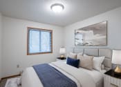 Thumbnail 5 of 32 - a bedroom with a large bed and a window. Fargo, ND Prairie Park Apartments