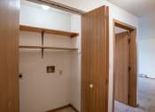 Thumbnail 12 of 32 - an empty room with a closet and an open door. Fargo, ND  Prairie Park Apartments