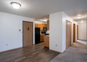 Thumbnail 9 of 32 - a dining room and kitchen with wood flooring and white walls. Fargo, ND  Prairie Park Apartments