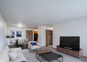 Thumbnail 1 of 32 - a living room with a couch and a coffee table and a television. Fargo, ND Prairie Park Apartments
