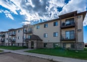 Thumbnail 31 of 32 - Fargo, ND Prairie Park Apartments. An apartment building with a cloudy sky in the background