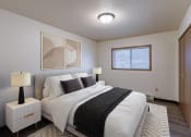 Thumbnail 2 of 21 - a bedroom with a large bed and a window. Fargo, ND Prairiewood Courts Apartments