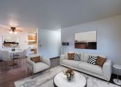 Thumbnail 1 of 21 - a living room with a couch and a table. Fargo, ND Prairiewood Courts Apartments