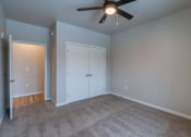 Thumbnail 15 of 26 - a bedroom with a ceiling fan and a closet. Fargo, ND Prairiewood Meadows