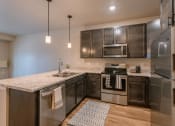 Thumbnail 9 of 26 - a kitchen with stainless steel appliances and a marble counter top. Fargo, ND Prairiewood Meadows | LivingFargo, ND Prairiewood Meadows