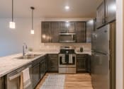 Thumbnail 10 of 26 - a kitchen with stainless steel appliances and granite countertops. Fargo, ND Prairiewood Meadows