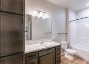 Thumbnail 22 of 26 - a bathroom with a sink and a toilet and a shower. Fargo, ND Prairiewood Meadows Apartments