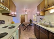 Thumbnail 6 of 20 - Fargo, ND Saddlebrook Apartments. a kitchen with a stove top oven next to a sink
