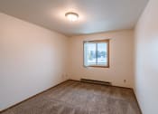 Thumbnail 14 of 22 - an empty living room with carpet and a window .Fargo, ND Sargent Apartments