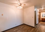 Thumbnail 11 of 22 - a living room with white walls and a ceiling fan. Fargo, ND Sargent Apartments