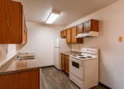 Thumbnail 8 of 22 - a kitchen with a stove refrigerator and sink. Fargo, ND Sargent Apartments