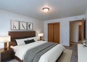 Thumbnail 3 of 10 - a bedroom with a large bed and a closet. Fargo, ND Schrock Apartments