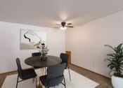 Thumbnail 2 of 10 - a dining room with a table and chairs and a ceiling fan. Fargo, ND Schrock Apartments