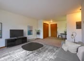 Thumbnail 1 of 17 - a living room with a couch and a coffee table and a tv. Fargo, ND Southgate Apartments