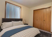 Thumbnail 2 of 17 - a bedroom with a bed and a closet. Fargo, ND Southgate Apartments