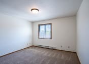 Thumbnail 20 of 25 - a bedroom with carpet and a window. Fargo, ND Southview Village Apartments