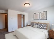 Thumbnail 3 of 25 - a bedroom with a large bed and a closet. Fargo, ND Southview Village Apartments