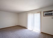 Thumbnail 15 of 25 - the living room of an empty apartment with a large window. Fargo, ND Southview Village Apartments