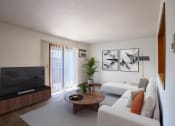 Thumbnail 1 of 25 - a living room with white furniture and a television. Fargo, ND Southview Village Apartments