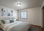 Thumbnail 6 of 25 - a bedroom with a bed and a window.Fargo, ND Southview Village Apartments