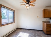 Thumbnail 10 of 25 - an empty kitchen with a ceiling fan and a window. Fargo, ND Southview Village Apartments