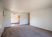 Thumbnail 7 of 25 - an empty living room with carpet and white walls. Fargo, ND Southview Village Apartments