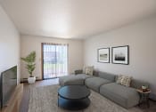 Thumbnail 4 of 25 - a living room with a gray couch and a tv. Fargo, ND Southview Village Apartments