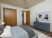 Thumbnail 3 of 10 - a bedroom with a closet, bed, and dresser. Fargo, ND Southwind Apartments
